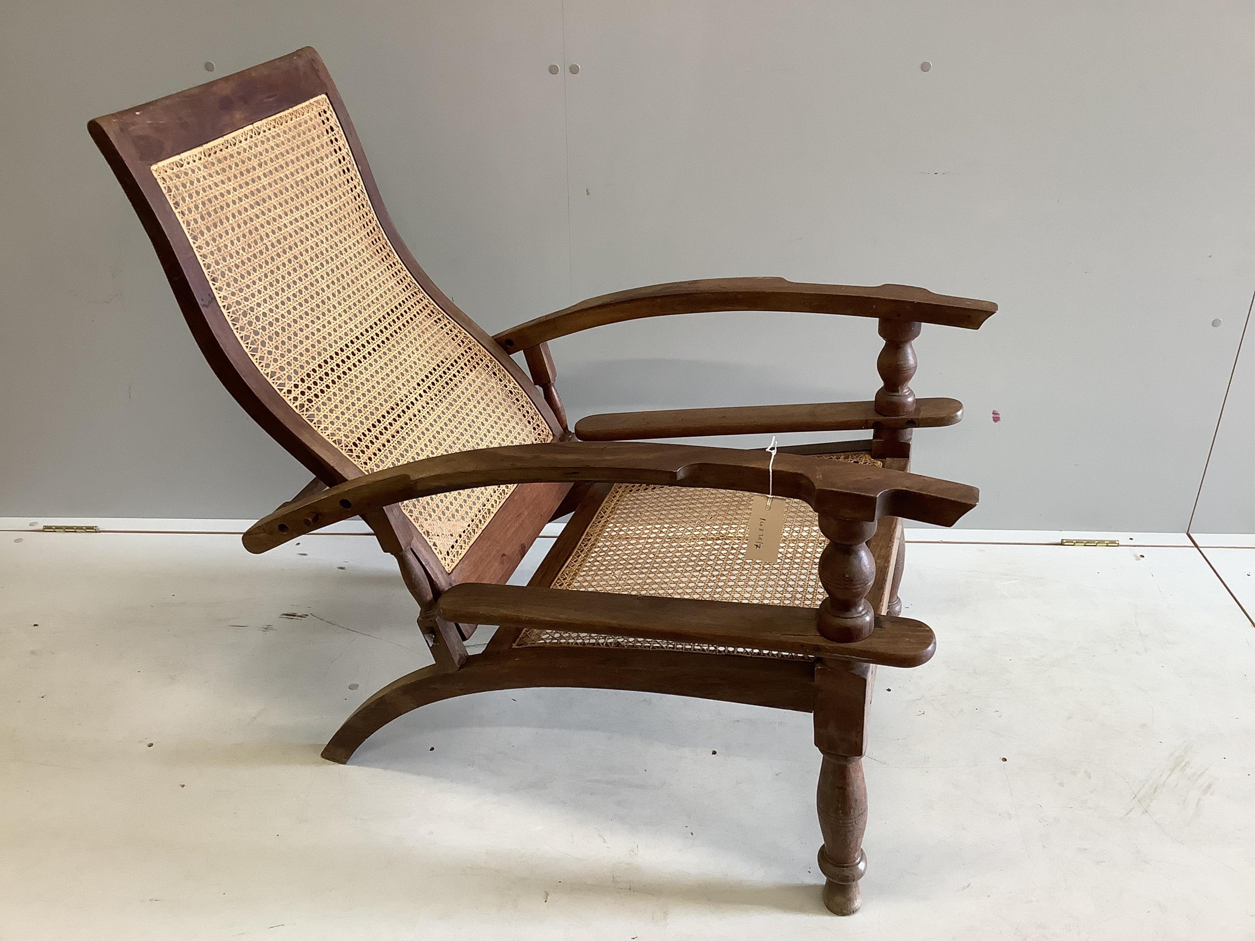 A caned hardwood plantation chair, width 63cm, depth 93cm, height 94cm. Condition - fair